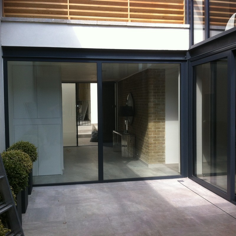 Floor-to-ceiling sliding doors opening to courtyard in East Finchley
