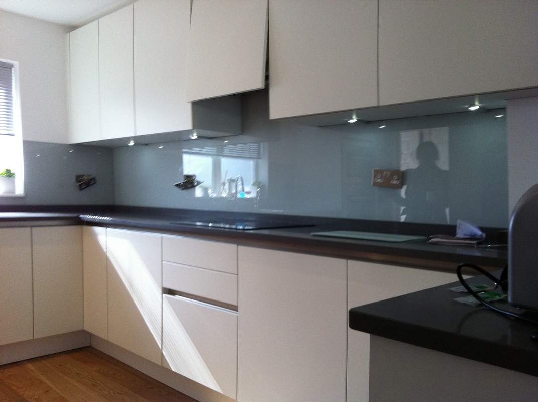 Grey glass kitchen splashback with LED lighting in East Finchley