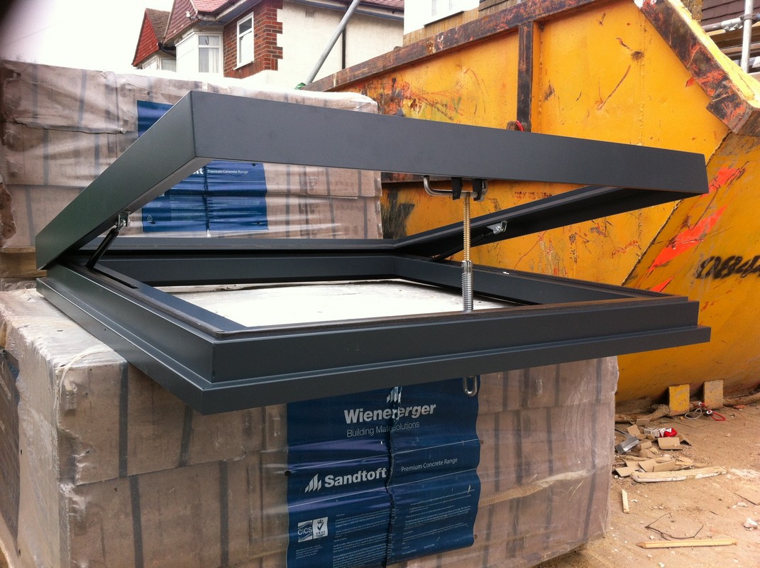 Opening flat roof skylight in anthracite grey installed in East Finchley