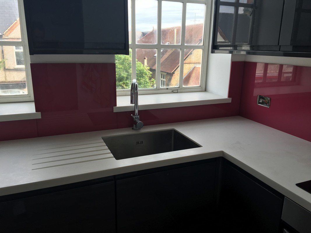 Deep plum coloured glass splashback in modern East Finchley kitchen