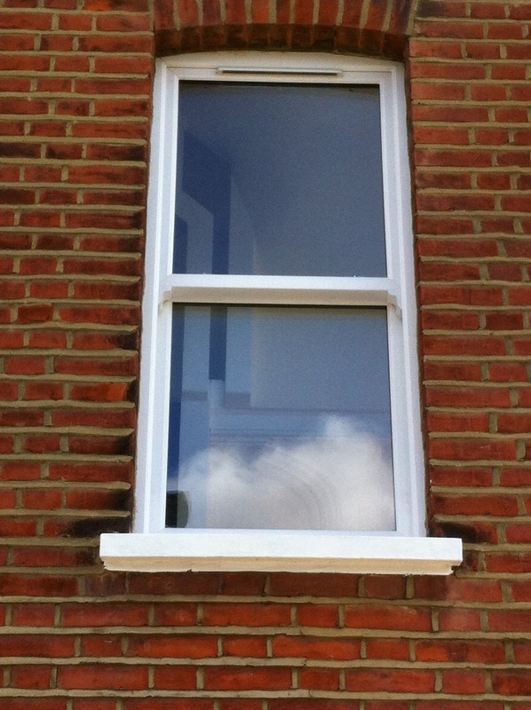 uPVC sash window on Victorian red brick house in East Finchley